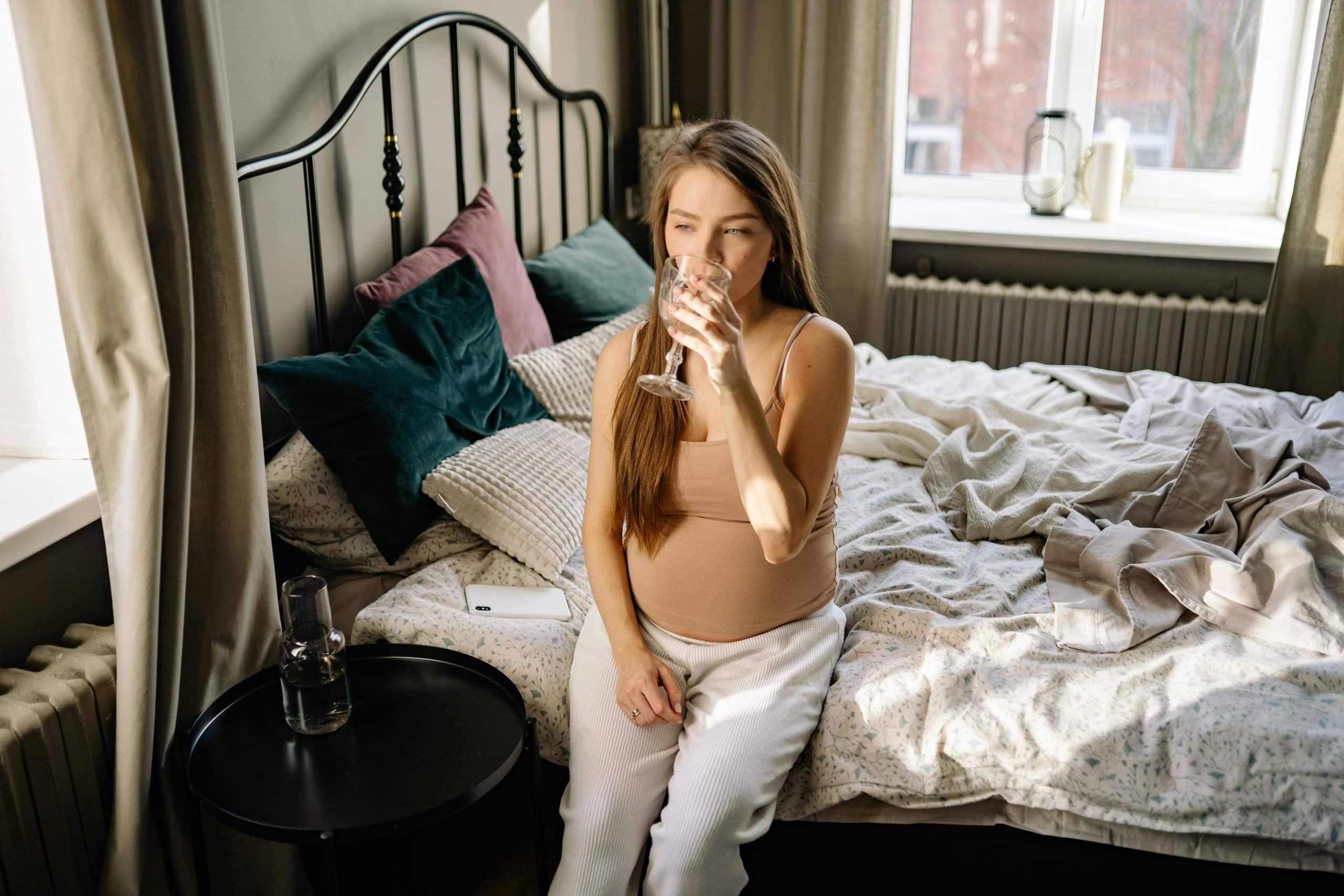 pregnant woman hydrating with water